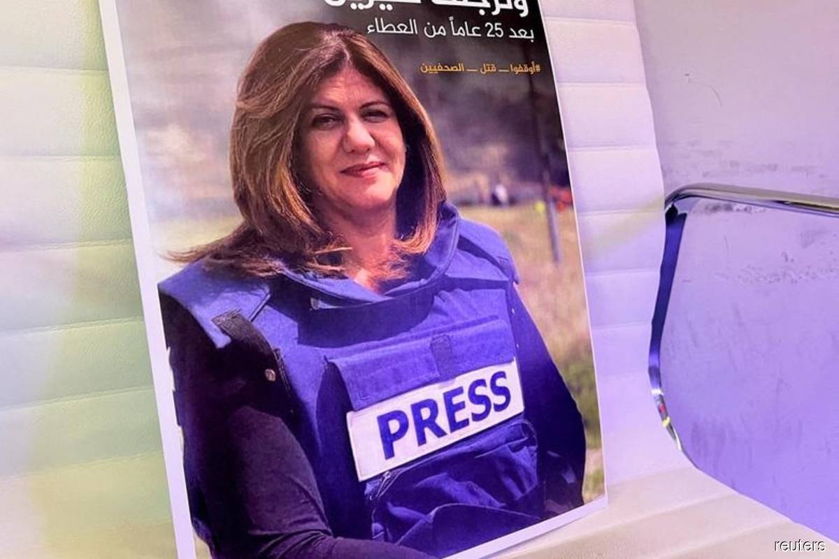 A picture of Al Jazeera reporter Shireen Abu Akleh displayed at the Al Jazeera headquarters building in Doha, Qatar on May 11, 2022. (Reuters filepix by Imad Creidi)