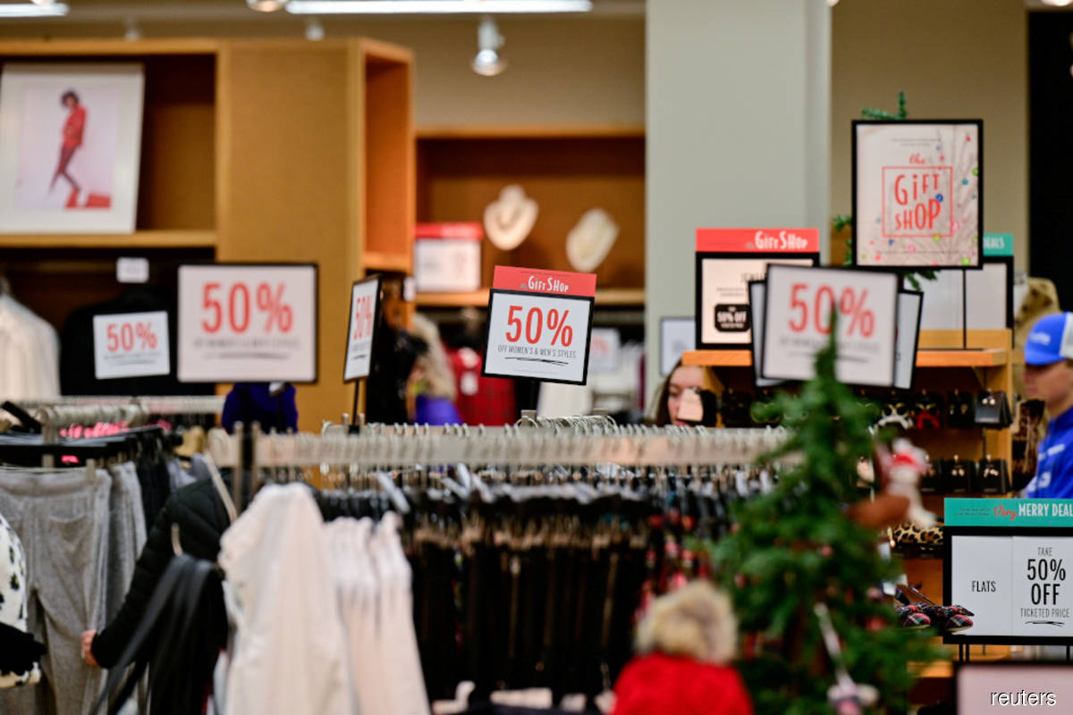 Placards showcasing discounted items are seen in a store as Black Friday sales begin at The Outlet Shoppes of the Bluegrass in Simpsonville, Kentucky, US on Friday, Nov 26, 2021. (Photo by Jonathan Cherry/Reuters)