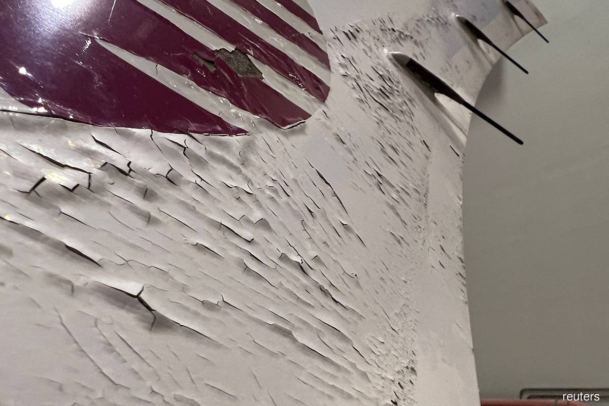The paint on the tail of one of the A350s emblazoned with Qatar Airways' maroon Arabian Oryx emblem was pockmarked by cracked and missing paint that exposed the layer beneath.