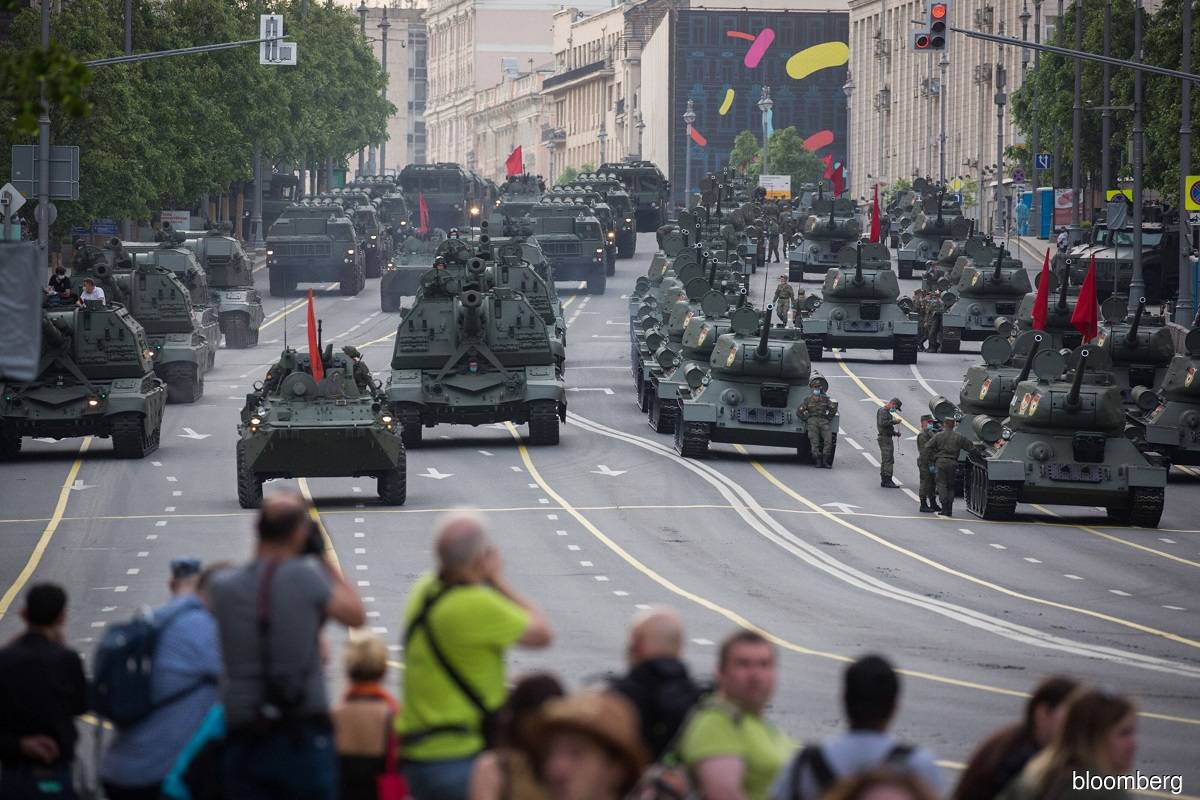 Crowds watch military vehicles and tanks pass through central Moscow during a Victory Day rehearsal in June 2020.