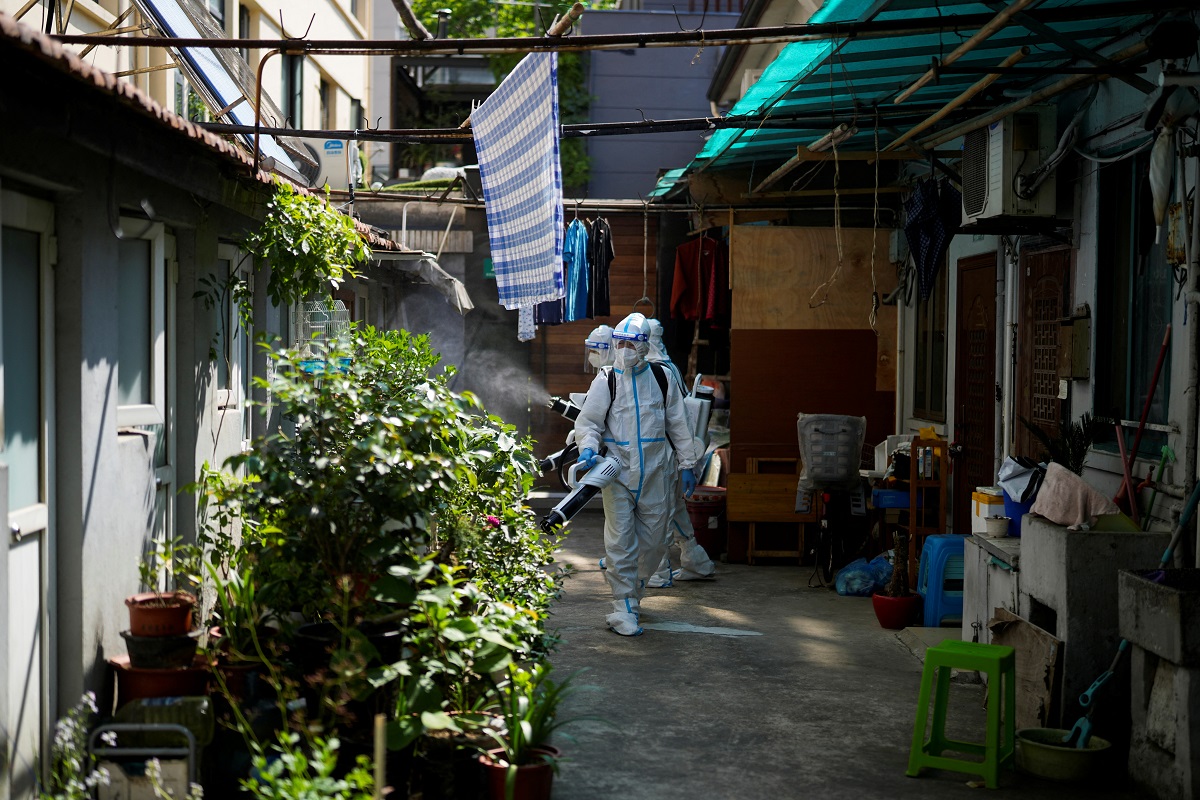 Workers in protective suits disinfect a closed residential area during lockdown, amid the Covid-19 outbreak, in Shanghai, China, May 18, 2022. (Photo by Reuters)