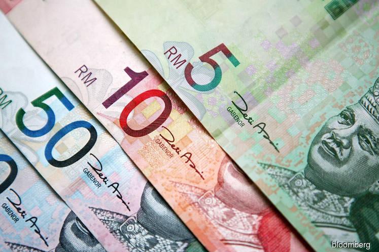 Ringgit edges lower after four weeks of gains