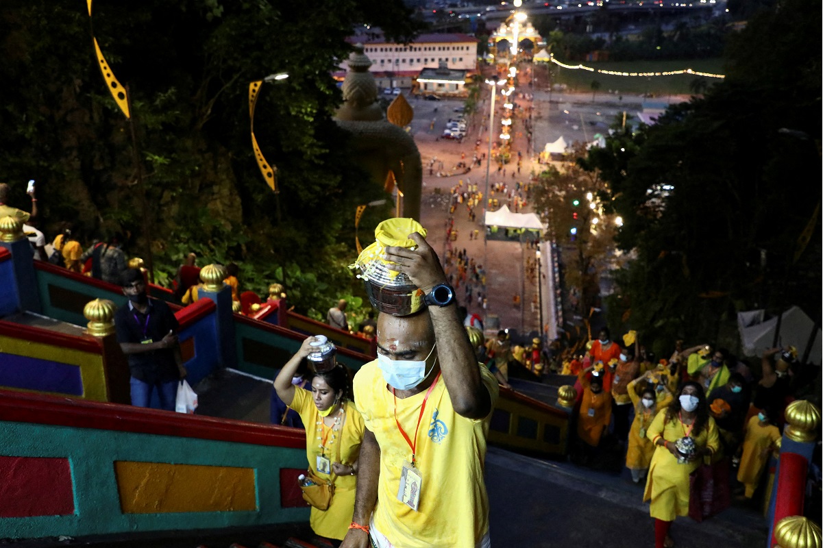Hindu devotees climb the 272 steps to Sri Subramaniar Swamy Temple during celebrations of Thaipusam, which resumed with tight health protocols after a one-year hiatus due to the Covid-19 pandemic, at Batu Caves, Jan 18, 2022. (Photo by Reuters)