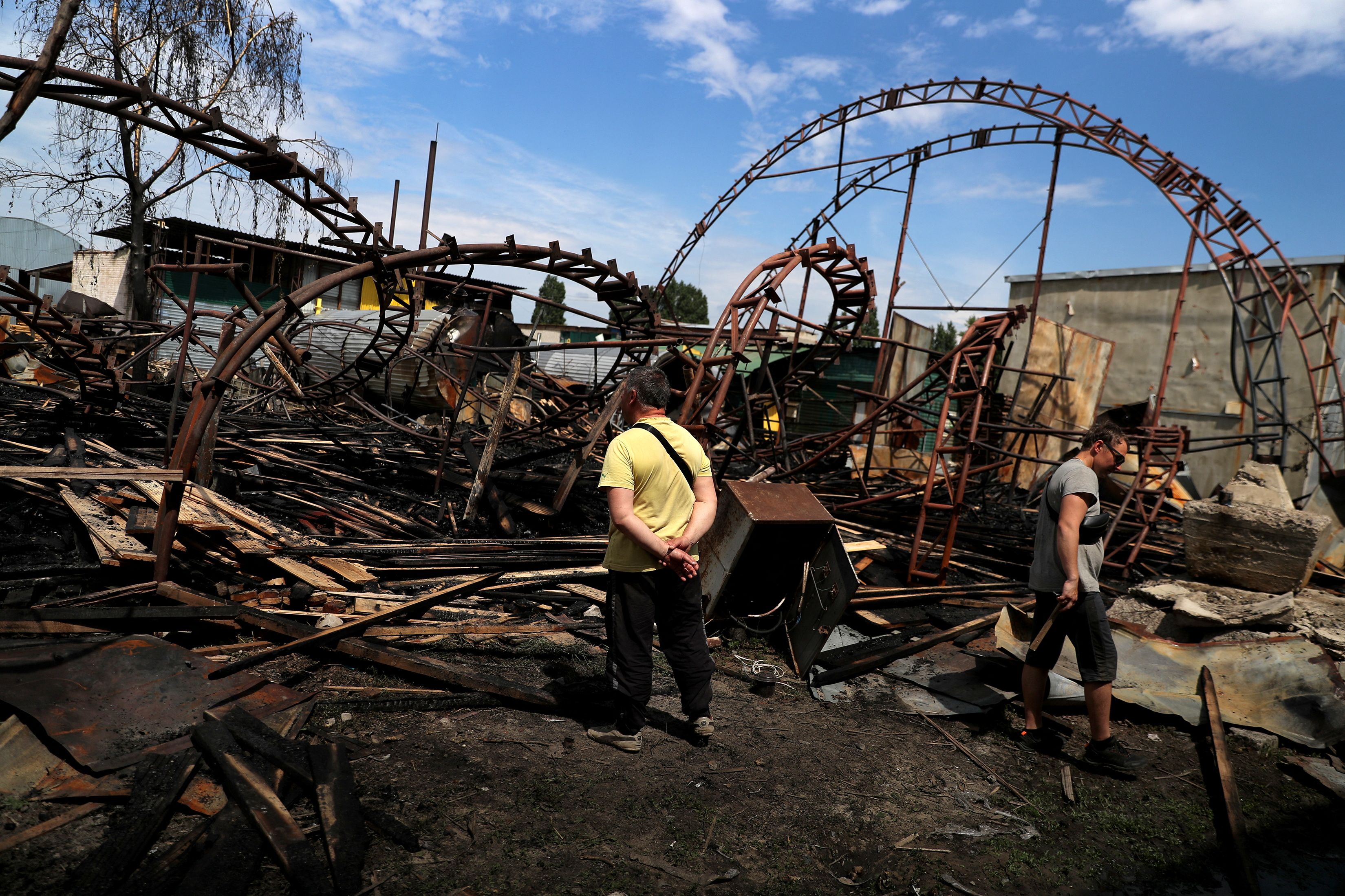 Workers inspect a damaged wood warehouse after a strike, amid Russia's attack on Ukraine, in the outskirt of Kharkiv, Ukraine June 3, 2022. (Photo by Reuters)