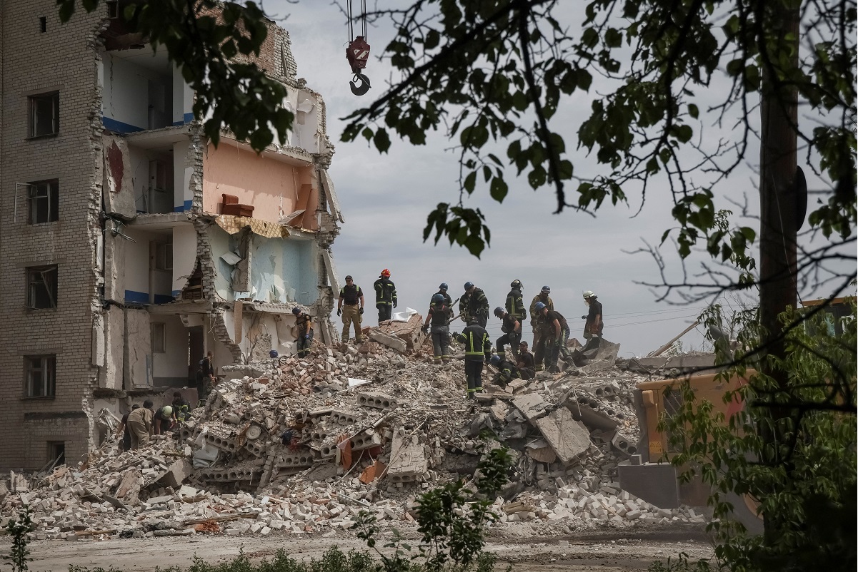 Rescuers work at a residential building damaged by a Russian military strike, amid Russia's invasion on Ukraine, in the town of Chasiv Yar, in Donetsk region, Ukraine July 10, 2022. (Photo by Reuters)