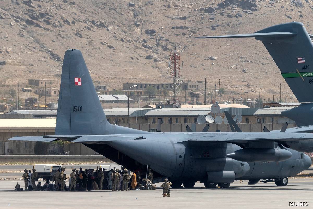 US Department of Defense service members defending military aircraft at the Hamid Karzai International Airport in Kabul, Afghanistan on Aug 17, 2021.